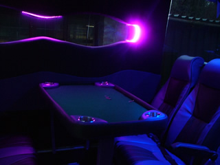 Chauffeur driven Party Bus limo hire Poker den interior in Bristol, Gloucester, Cheltenham, Cardiff, Wales, Weston Super Mare, and Bath.