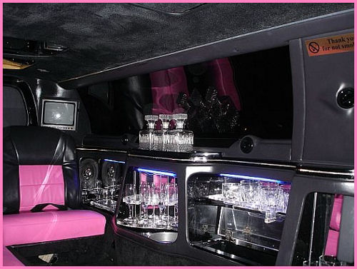 Chauffeur stretched pink limousine hire interior in UK